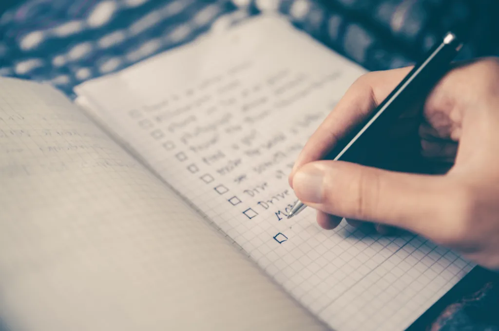 Close up of hand writing in a notebook.