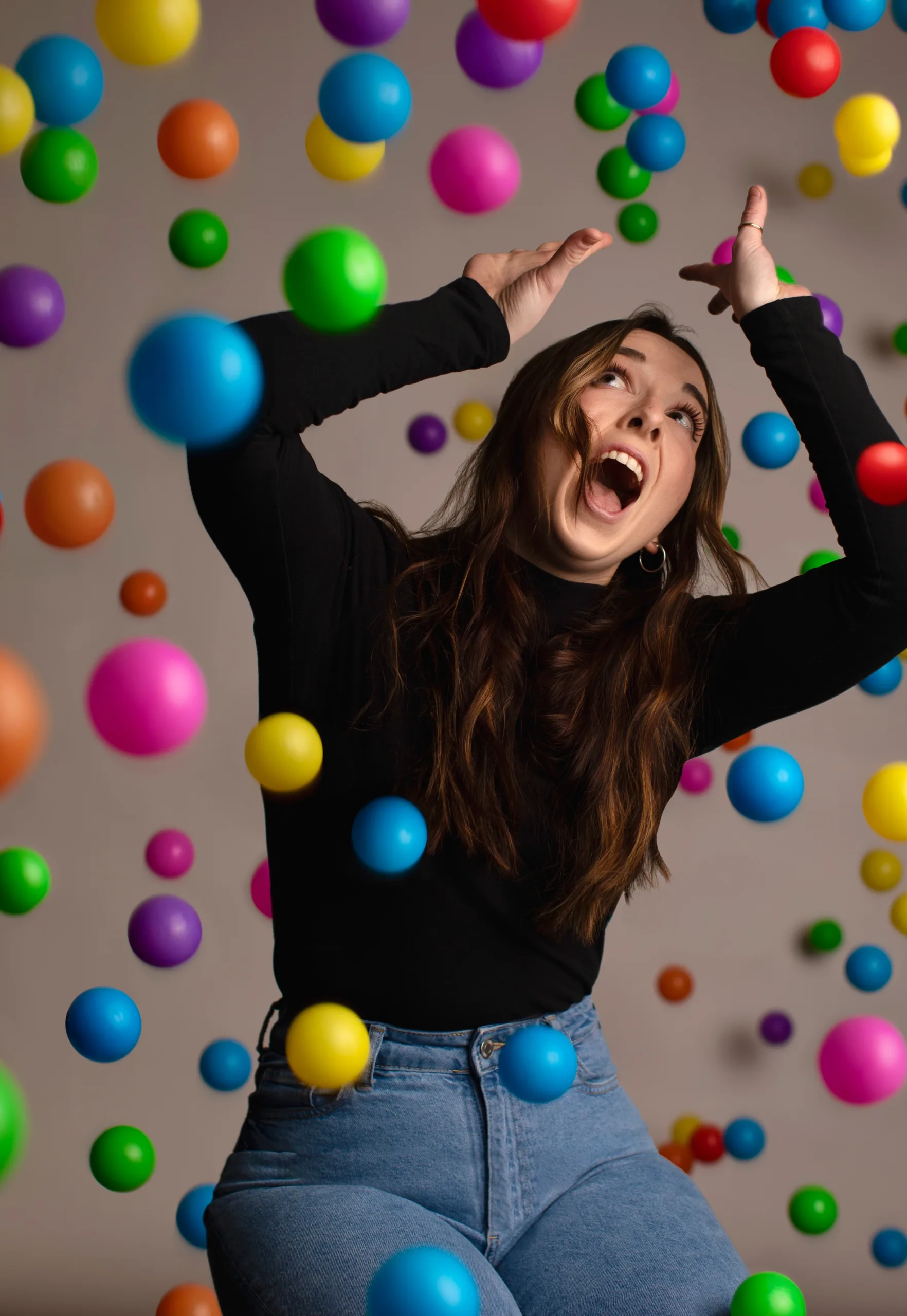 Woman looking surprised in a ball pit.